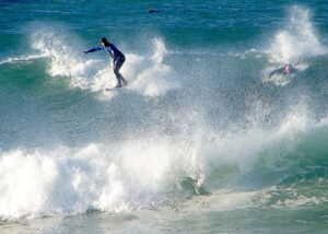 Surfer_at_Noordhoek_Beach_South_Africa-OlgaErnst-CC-BY-SA-4.0